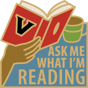 "Ask Me What I'm Reading" enamel pin created by the Vanderbilt Libraries
